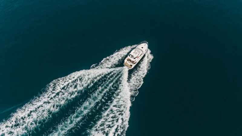Bateau à moteur naviguant en pleine mer, vu du ciel